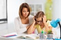 Mother helping daughter with difficult homework Royalty Free Stock Photo