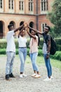 Education and friendship concept. Happy students giving high five at school Royalty Free Stock Photo