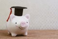 Education fund, Scholarships, university cost and expense or saving for student loan concept, smiling pink piggy bank wearing Royalty Free Stock Photo