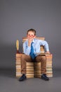 Education funny concept. A boy student sitting on a throne from