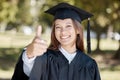 Education, graduation and portrait of girl with thumbs up on campus for success, award and certificate ceremony