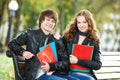 Education and students. Happy young college student with notebooks on bench Royalty Free Stock Photo