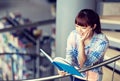 High school student girl reading book at library Royalty Free Stock Photo