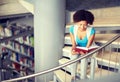 African student girl reading book at library Royalty Free Stock Photo