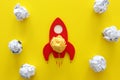 Education or innovation concept. Wooden rocket over yellow background