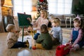 Education, kindergarten people concept. Young woman teacher with children playing together Royalty Free Stock Photo