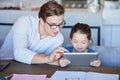 Education, learning and child development on digital tablet with father and daughter watching educational program at a Royalty Free Stock Photo