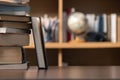 Education learning concept. Book in library with old open textbook, stack piles of literature text archive on reading desk, aisle