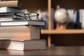 Education learning concept. Book in library with old open textbook, stack piles of literature text archive on reading desk, aisle