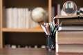 Education learning concept. Book in library with old open textbook, stack piles of literature text archive on reading desk, aisle