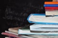 School books on desk, Back to school supplies. Books and blackboard on wooden background, education concept Royalty Free Stock Photo