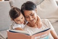 Education, learning and girl and grandmother reading a book on a sofa, relax and bonding in living room. Children, love Royalty Free Stock Photo