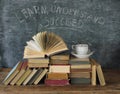 education,learning,knowledge concept,books and blackboard with slogan learn,understand,succeed, also business concept Royalty Free Stock Photo