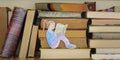 education,learning,knowledge concept,books on a shelf with drawing of a girl reading a book Royalty Free Stock Photo