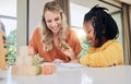 Education, learning and woman help girl with homework, school and teaching with growth and development in family home Royalty Free Stock Photo