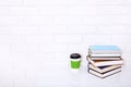 Education literature. Cup of coffee and books on the table in a class. Top view and copy space. Selective focus Royalty Free Stock Photo
