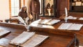 Education in the Middle Ages concept. Class in a medieval university with Jesuit monks as teachers. Old manuscripts and paper with Royalty Free Stock Photo