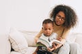 Education mother giving learning to little boy child interesting to read the book for smart kid, African black people family Royalty Free Stock Photo