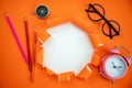 Education objects on orange ripped open paper background copy space for your message on torn paper Royalty Free Stock Photo