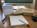 Education and online learning concept. Books, a notebook, pens and a computer mouse are on the table in front of the monitor. Royalty Free Stock Photo