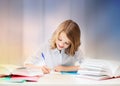 Student girl with books writing in notebook