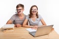 Education and people concept - a couple of young students in glasses look like they are bored of learning homework and Royalty Free Stock Photo