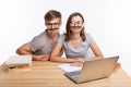 Education and people concept - a couple of young students in glasses look like they are bored of learning homework and Royalty Free Stock Photo