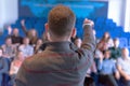 Education process at professor`s lecture in audience. Young male teacher giving presentation for students in a lecture hall Royalty Free Stock Photo