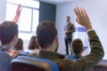 Education process at professor`s lecture in audience. Young male teacher giving presentation for students in a lecture hall Royalty Free Stock Photo
