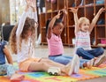 Education, raise hands and children in kindergarten in a classroom for education or knowledge. Daycare, happy and young Royalty Free Stock Photo