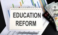 Education reform text written on the notebook with chart,calculator and dollars