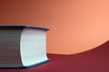 Education and rising concept. Thick book on red and coral background Royalty Free Stock Photo