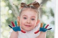 education, school, art and painitng concept - little student girl showing painted hands Royalty Free Stock Photo