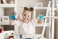 education, school, art and painitng concept - little student girl showing painted hands Royalty Free Stock Photo