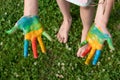 education, school, art and painitng concept - little student girl showing painted hands at school on grass Royalty Free Stock Photo