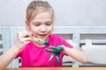 Education, school, art and painting concept - beautiful happy smiling little girl paints her hands Royalty Free Stock Photo