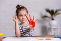 Education, school, art and painting concept - smiling little student girl showing painted hands at school Royalty Free Stock Photo