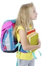 Education, school concept, A beautiful pretty little girl with backpack and books looking up at copy space. Royalty Free Stock Photo