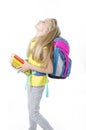 Education, school concept, A beautiful pretty little girl with backpack and books looking up. Royalty Free Stock Photo