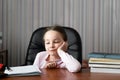 education and school concept little girl sitting at home doing homework. Fatigue and heavy loads on the children& x27;s body Royalty Free Stock Photo