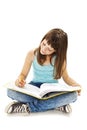 Education and school concept - little student girl sitting on floor and reading book Royalty Free Stock Photo