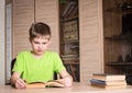 Education and school concept. Surprised boy student reading a bo Royalty Free Stock Photo