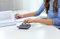 Student girl counting on calculator at home Royalty Free Stock Photo