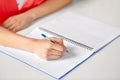 Hands of student girl with pen writing to notebook Royalty Free Stock Photo