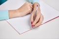 Hands of student girl with pen writing to notebook Royalty Free Stock Photo