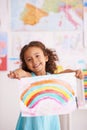 Education, school and portrait of girl with rainbow painting in a classroom for creative, learning or child development Royalty Free Stock Photo