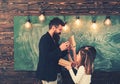 Education and school. Teacher write with chalk on chalkboard. Little girls listen to bearded man at school board. Tutor Royalty Free Stock Photo