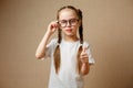 smiling cute little girl with black eyeglasses showing thumbs up Royalty Free Stock Photo