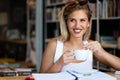 Education, study and home concept. Happy smiling student girl studying, learning for exam Royalty Free Stock Photo