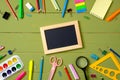 Education, studying and back to school concept. Border frame made of stationery and empty picture frame on wooden background with Royalty Free Stock Photo